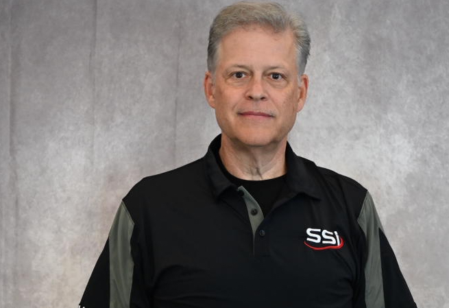 Man in black SSI polo shirt.