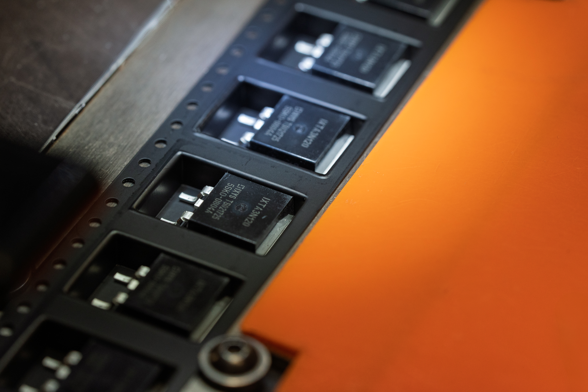 Microchips on an orange background surface.